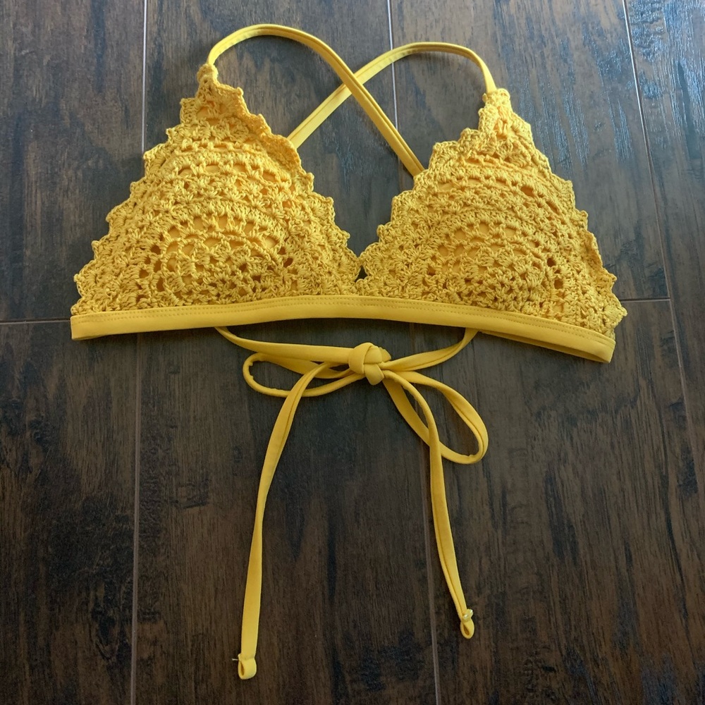 Yellow crocheted bathing suit top.